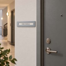 Dörrskylt Lupus vid sidan av lägenhetsgörr